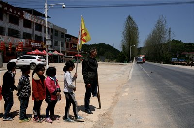 独腿老师护送学生过马路25年:孩子是山里的希
